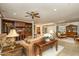 Cozy living room featuring built-in shelving, a ceiling fan, and seamless access to the dining area at 20562 N Bear Canyon Ct, Surprise, AZ 85387