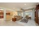 Open-concept living room with tile flooring, a ceiling fan, and easy access to the kitchen at 20562 N Bear Canyon Ct, Surprise, AZ 85387