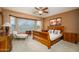 Spacious main bedroom with large bay window, a ceiling fan and an en-suite bathroom at 20562 N Bear Canyon Ct, Surprise, AZ 85387