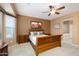 Main bedroom, features ceiling fan, spacious layout and an en-suite bathroom at 20562 N Bear Canyon Ct, Surprise, AZ 85387