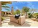 Outdoor kitchen with built in grill, seating and beautiful landscaping at 20562 N Bear Canyon Ct, Surprise, AZ 85387