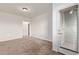 Bedroom featuring soft carpet, a window, and a door to an outdoor space at 2323 E Huntington Dr, Phoenix, AZ 85040