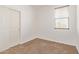 Cozy bedroom with neutral carpet, a sliding closet door, and a window for natural light at 2323 E Huntington Dr, Phoenix, AZ 85040