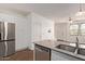 Bright kitchen with stainless steel appliances and granite countertops flows into the dining area at 2323 E Huntington Dr, Phoenix, AZ 85040