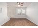 Inviting living room with wood floors, large windows, and modern ceiling fan, providing ample natural light at 2323 E Huntington Dr, Phoenix, AZ 85040