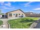 Landscaped backyard with an exterior home view, gravel landscaping and green grass at 3013 W Pollack St, Phoenix, AZ 85041