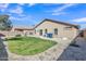 Spacious backyard featuring a grassy area, gravel landscaping, and an exterior home view at 3013 W Pollack St, Phoenix, AZ 85041