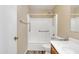 Bathroom featuring a toilet, a sink with storage, a bathtub/shower combo, and wood-like flooring at 3013 W Pollack St, Phoenix, AZ 85041