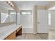 Well-lit bathroom featuring a large vanity and tub shower combo with wood-look flooring at 3013 W Pollack St, Phoenix, AZ 85041