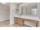 Bathroom featuring a full vanity with well lit mirror and wood-look flooring at 3013 W Pollack St, Phoenix, AZ 85041