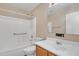 Bathroom with a toilet, sink and bathtub-shower combo, and safety bars at 3013 W Pollack St, Phoenix, AZ 85041