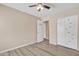 A well-lit bedroom with wood floors, a closet and a ceiling fan at 3013 W Pollack St, Phoenix, AZ 85041