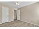 A well-lit bedroom featuring wood floors, a ceiling fan, and closet or bathroom access at 3013 W Pollack St, Phoenix, AZ 85041