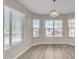 Bright dining area featuring large windows, laminate flooring, and natural light with backyard view at 3013 W Pollack St, Phoenix, AZ 85041