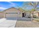 Charming single-story home featuring a two-car garage, desert landscaping, and a welcoming entrance at 3013 W Pollack St, Phoenix, AZ 85041