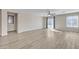 Spacious living room with ceiling fan, natural light, and sliding glass doors to the backyard at 3013 W Pollack St, Phoenix, AZ 85041