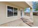 Covered patio featuring pavers, a window, exterior door and desert landscaping in the backyard at 30404 N 43Rd St, Cave Creek, AZ 85331