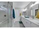 Bright bathroom featuring double sinks, a glass shower, and modern fixtures at 30404 N 43Rd St, Cave Creek, AZ 85331