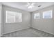 Bedroom with three windows, ceiling fan, and neutral carpet at 30404 N 43Rd St, Cave Creek, AZ 85331