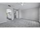 Neutral bedroom with carpet, ceiling fan, and doorway to bathroom at 30404 N 43Rd St, Cave Creek, AZ 85331