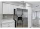 Kitchen area features stainless steel refrigerator and white cabinets for ample storage at 30404 N 43Rd St, Cave Creek, AZ 85331