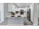 Modern white kitchen featuring stainless steel appliances, solid surface countertops and tile flooring at 30404 N 43Rd St, Cave Creek, AZ 85331