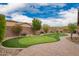 Landscaped backyard features artificial grass putting green and desert foliage at 3209 W Spur Dr, Phoenix, AZ 85083