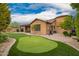 Panoramic view of the landscaped backyard with artificial grass, putting green and outdoor kitchen at 3209 W Spur Dr, Phoenix, AZ 85083