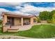 A paver patio area features a putting green, dining area and outdoor kitchen at 3209 W Spur Dr, Phoenix, AZ 85083