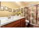 Bathroom featuring wood cabinetry, neutral countertops, and a shower-tub combo at 3209 W Spur Dr, Phoenix, AZ 85083