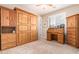 Cozy bedroom featuring a wooden roll-top desk and Murphy bed, maximizing space and style at 3209 W Spur Dr, Phoenix, AZ 85083