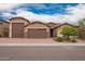 Charming single-story home with a three-car garage and brick driveway, professionally landscaped at 3209 W Spur Dr, Phoenix, AZ 85083