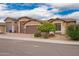 Beautiful home exterior with a brick driveway, three-car garage, and mature desert landscaping at 3209 W Spur Dr, Phoenix, AZ 85083