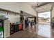 Spacious garage with open door, shelving, work bench, and storage for tools and equipment at 3209 W Spur Dr, Phoenix, AZ 85083