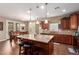 This kitchen boasts an island with bar seating, a tile backsplash, and wood cabinetry at 3209 W Spur Dr, Phoenix, AZ 85083