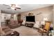 Cozy living room with plush carpeting, ceiling fan, and neutral tones at 3209 W Spur Dr, Phoenix, AZ 85083