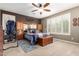 Cozy main bedroom featuring soft carpet, a ceiling fan, and built-in storage cabinets at 3209 W Spur Dr, Phoenix, AZ 85083