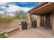 Outdoor kitchen on a brick patio features a built-in grill and smoker at 3209 W Spur Dr, Phoenix, AZ 85083