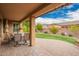 Covered patio featuring a brick floor, ceiling fan, and an outdoor dining table at 3209 W Spur Dr, Phoenix, AZ 85083