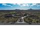 An aerial view of the community showcases the desert landscape and mountain views at 34463 N 99Th Way, Scottsdale, AZ 85262