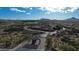 An aerial view showcasing the community entrance and surrounding desert landscape at 34463 N 99Th Way, Scottsdale, AZ 85262