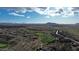 An aerial view shows the homes, desert landscape, and community golf course at 34463 N 99Th Way, Scottsdale, AZ 85262