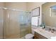 Bathroom with a sliding glass door shower, wooden vanity, and warm paint at 34463 N 99Th Way, Scottsdale, AZ 85262