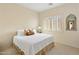 Cozy bedroom with white bedding, a decorative mirror, and plantation shutters at 34463 N 99Th Way, Scottsdale, AZ 85262