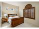 Cozy bedroom features a wooden bed frame, shuttered windows, and neutral color scheme at 34463 N 99Th Way, Scottsdale, AZ 85262