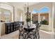 Well-lit dining room featuring a chandelier, unique decor, and courtyard views at 34463 N 99Th Way, Scottsdale, AZ 85262