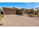 Beautiful home exterior featuring a well manicured desert landscaped yard and brick driveway at 34463 N 99Th Way, Scottsdale, AZ 85262