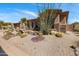 Beautiful home with desert landscaping, barrel cacti, and gravel groundcover at 34463 N 99Th Way, Scottsdale, AZ 85262