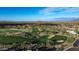 Scenic aerial view of a golf course and upscale homes in a desert setting at 34463 N 99Th Way, Scottsdale, AZ 85262