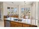 Gourmet kitchen island with sink, seating, and scenic views from the surrounding windows at 34463 N 99Th Way, Scottsdale, AZ 85262